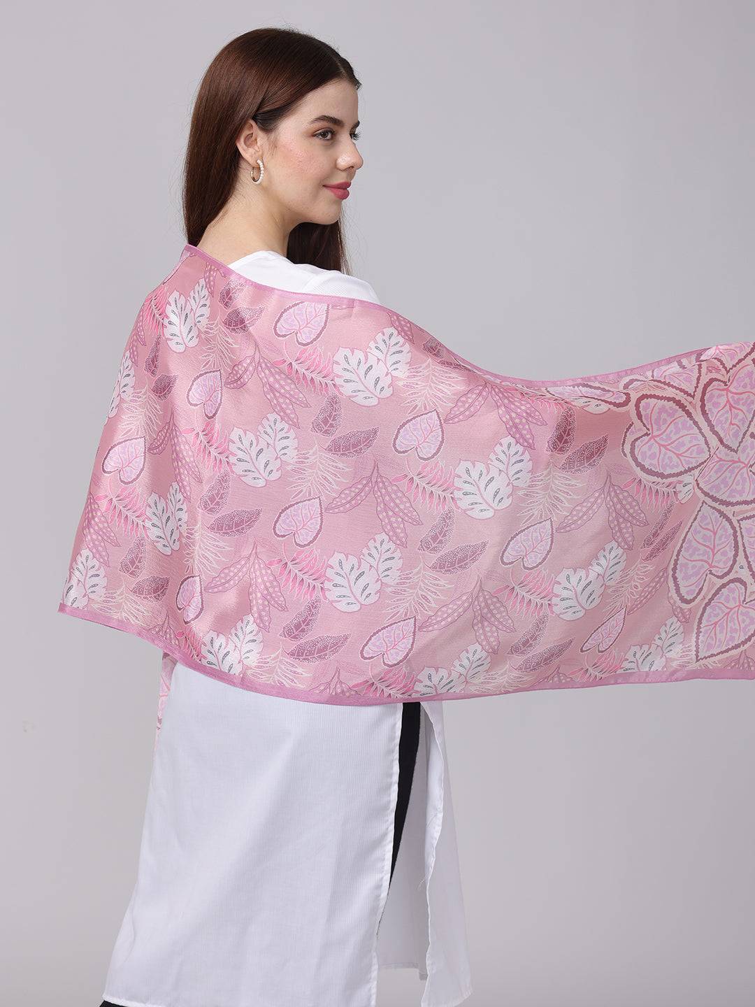 Close-up of pink leaf pattern scarf on model.