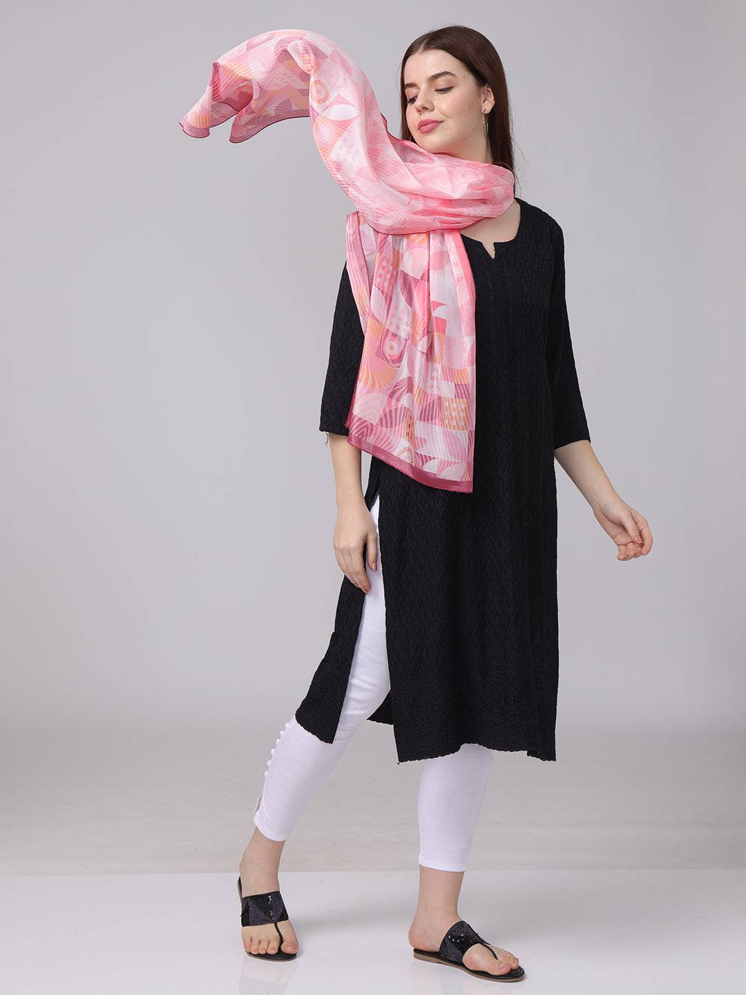 Flowing pink geometric scarf with abstract patterns.