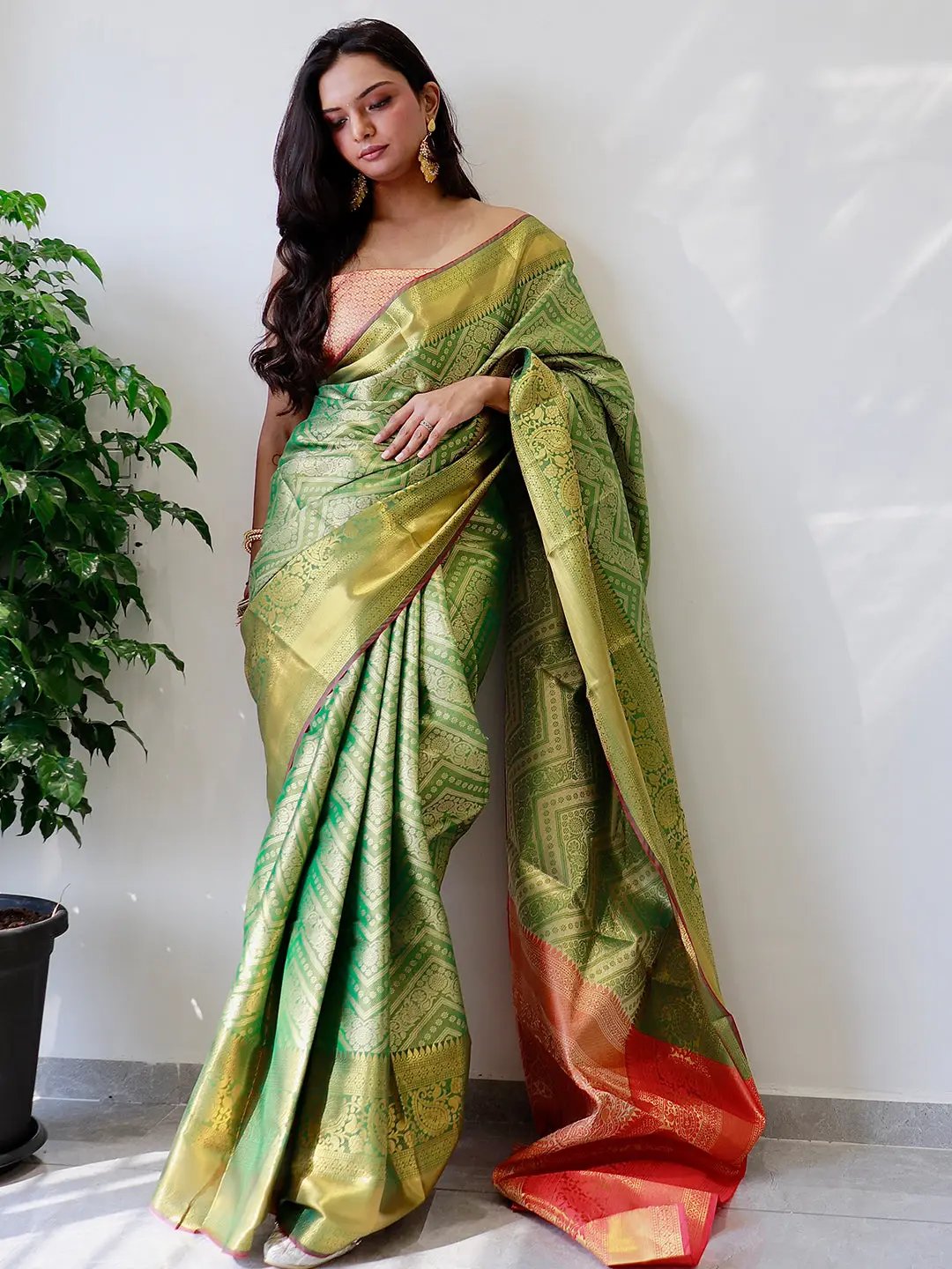 Graceful gold zari Kanjivaaram saree with traditional motifs.