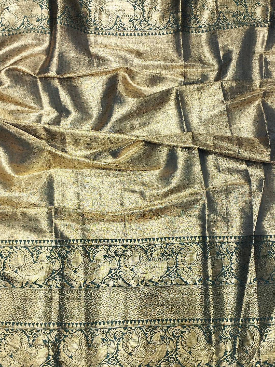 Close-up of gold Banarasi saree fabric with patterns