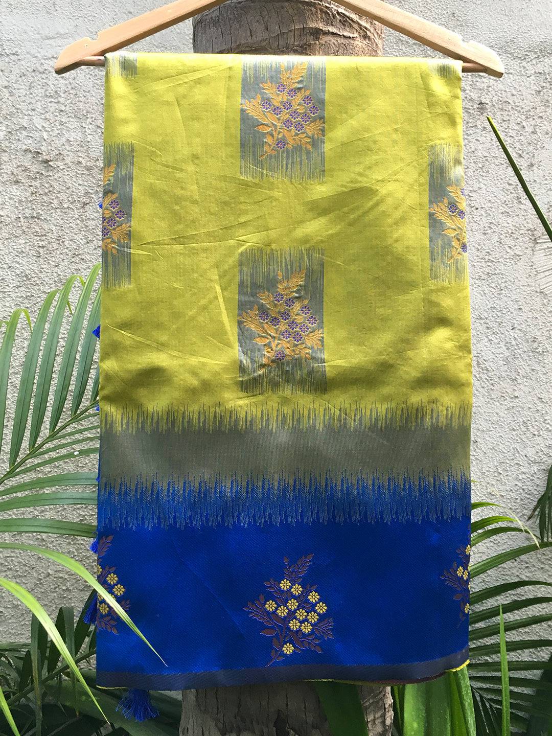 Blue and green Banarasi silk saree draped on hanger