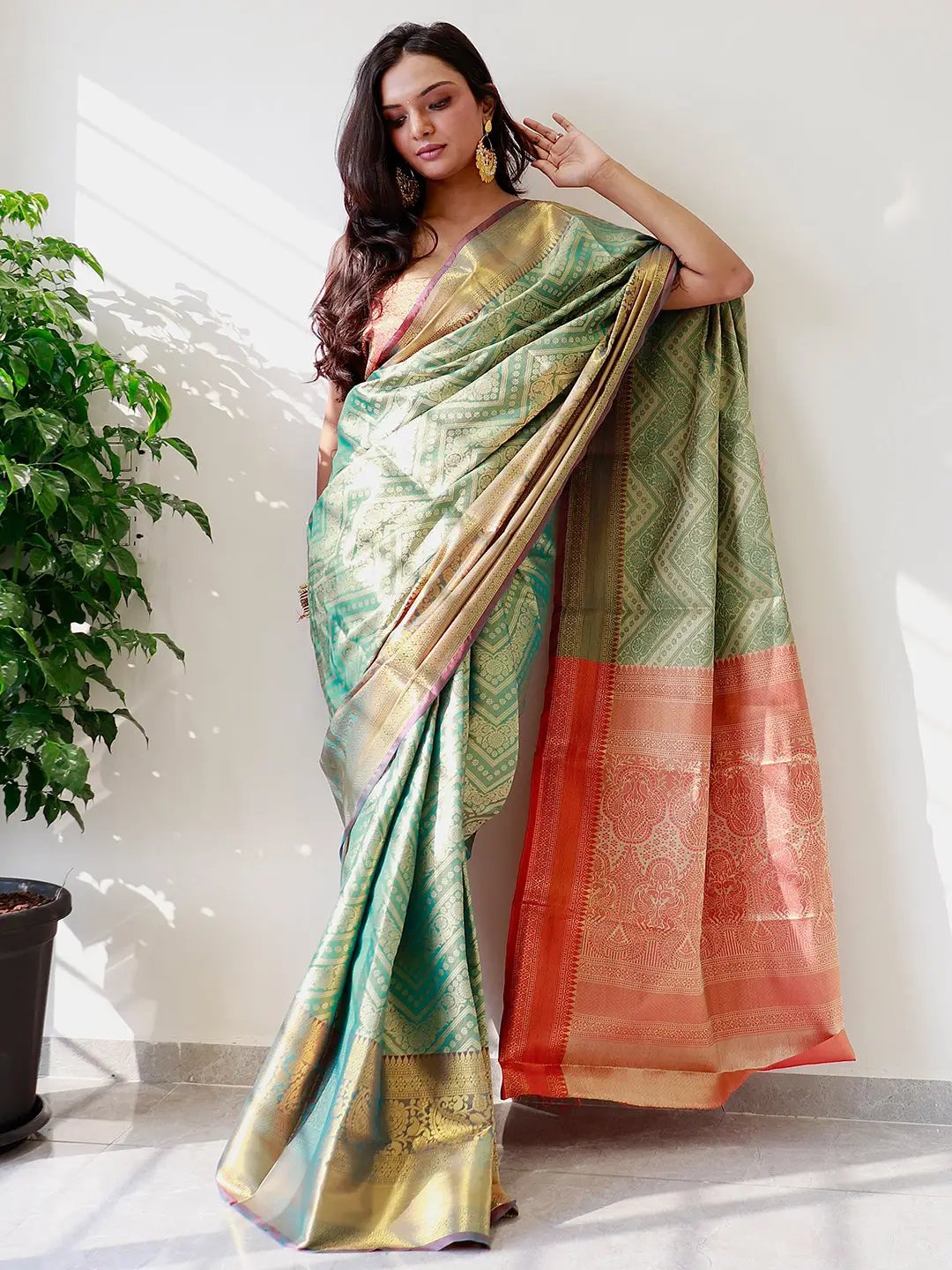 Model showcasing gold zari Kanjivaaram pattu silk saree.