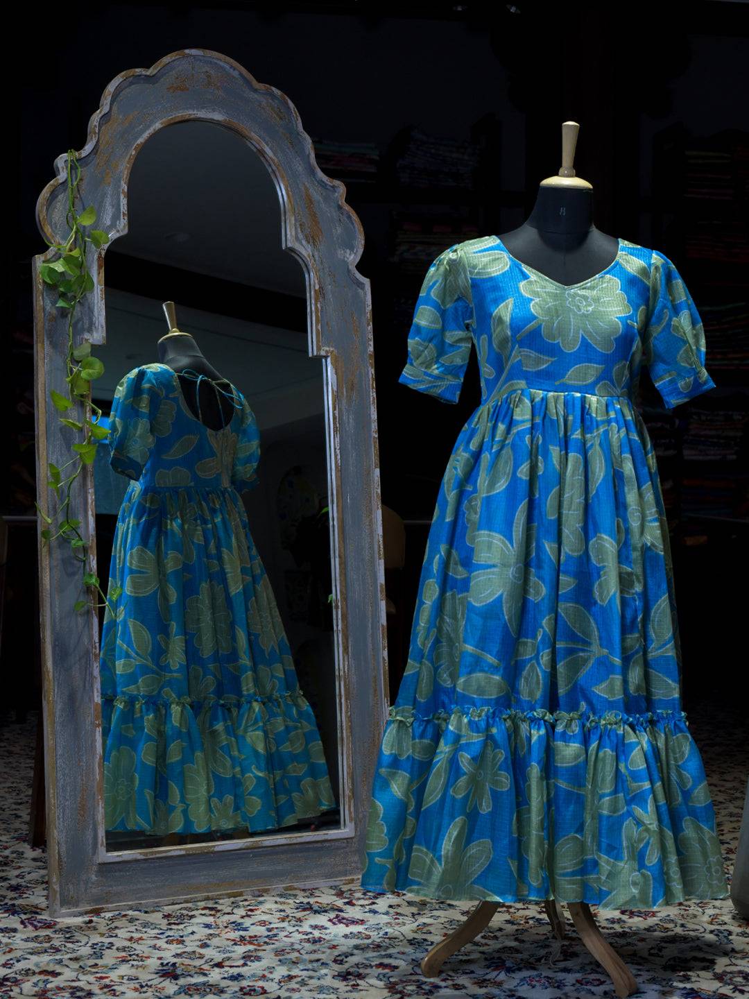 Torpical teal floral dress displayed on mannequin