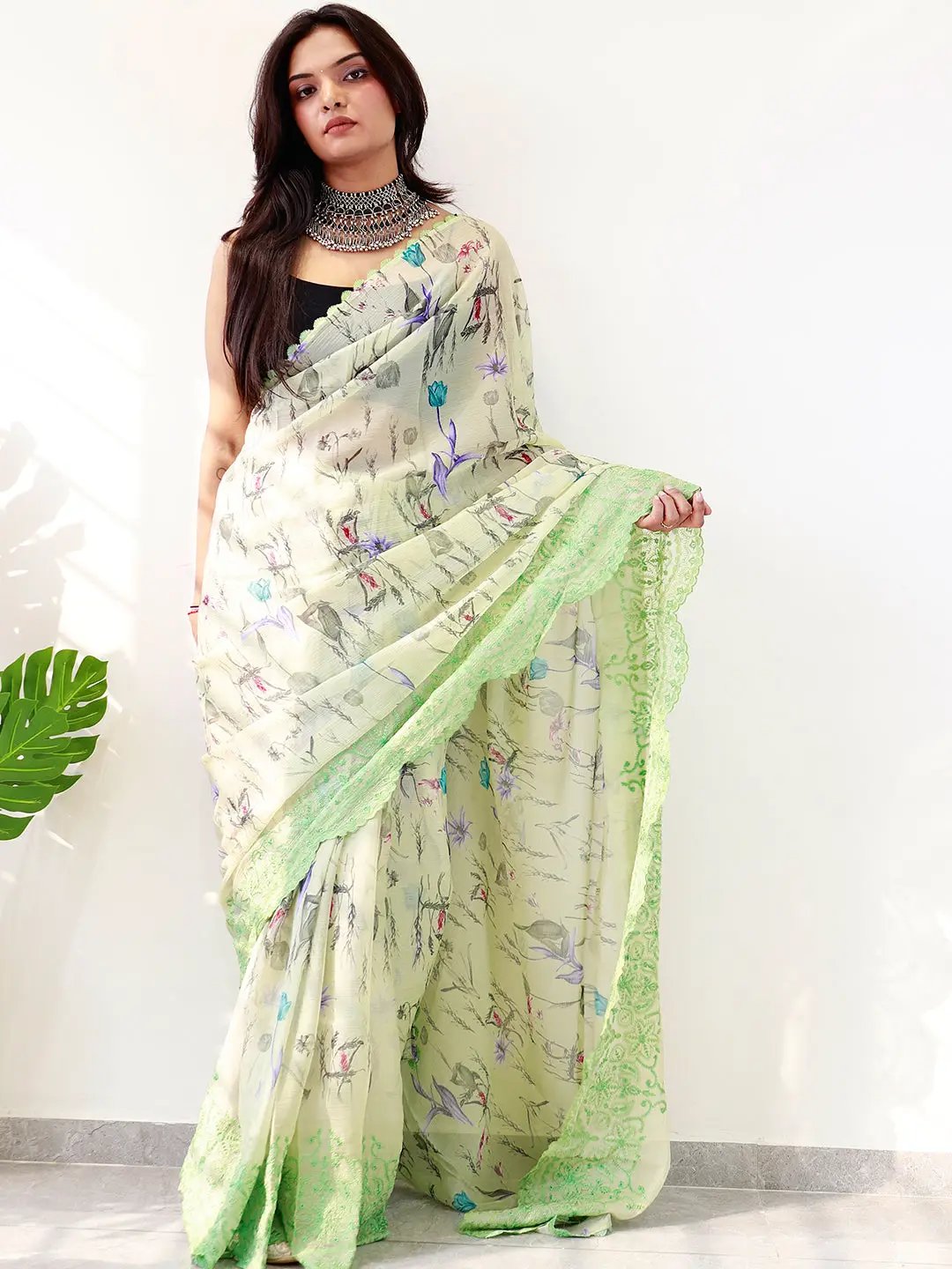 Soft chiffon satin saree with floral print and green embroidered border.