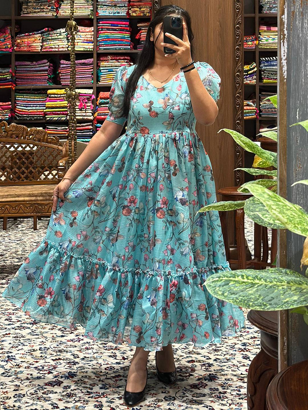 Stylish powder blue floral dress with puff sleeves and ruffled hem.