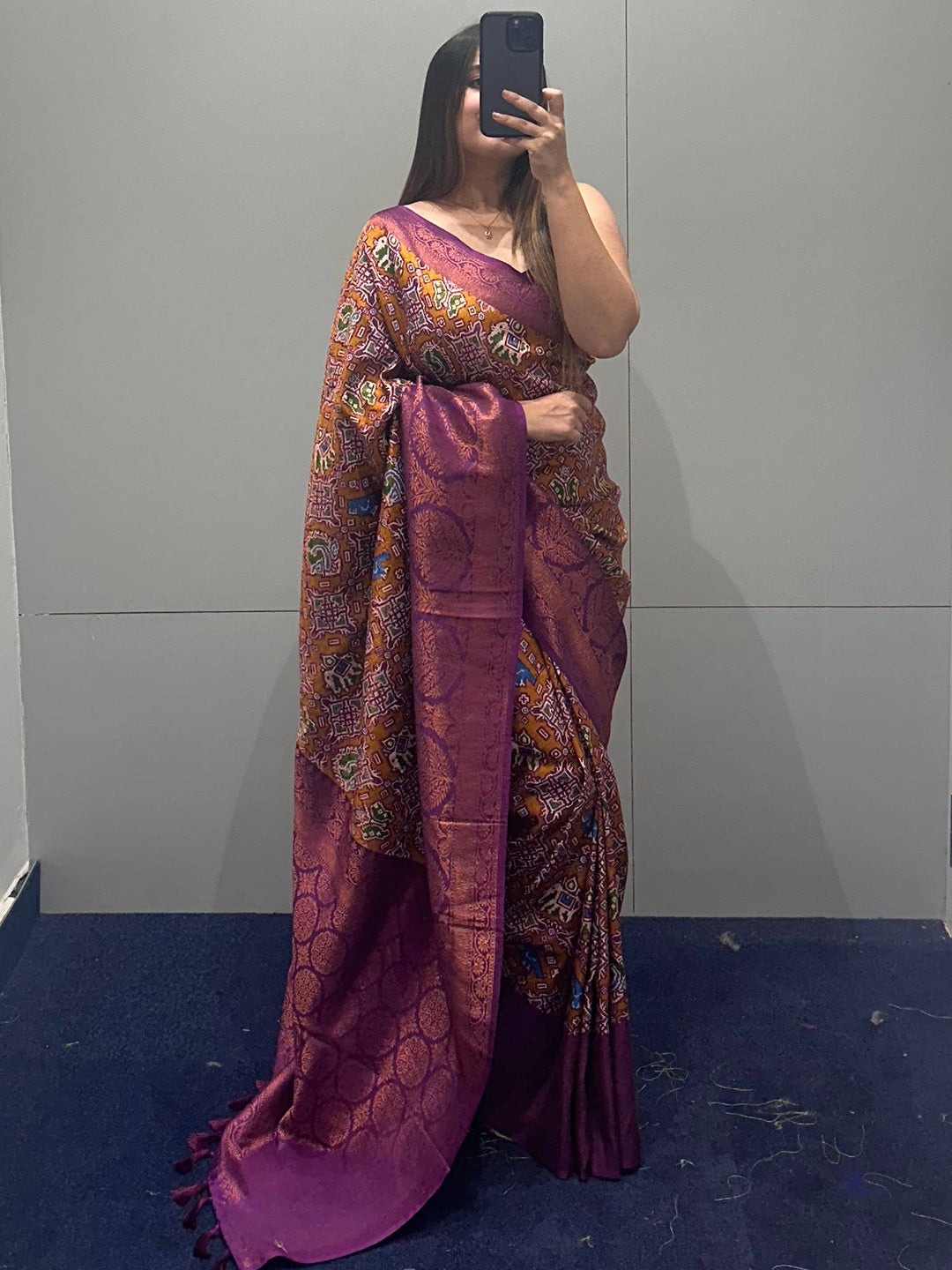 Purple Patola saree with intricate designs on display