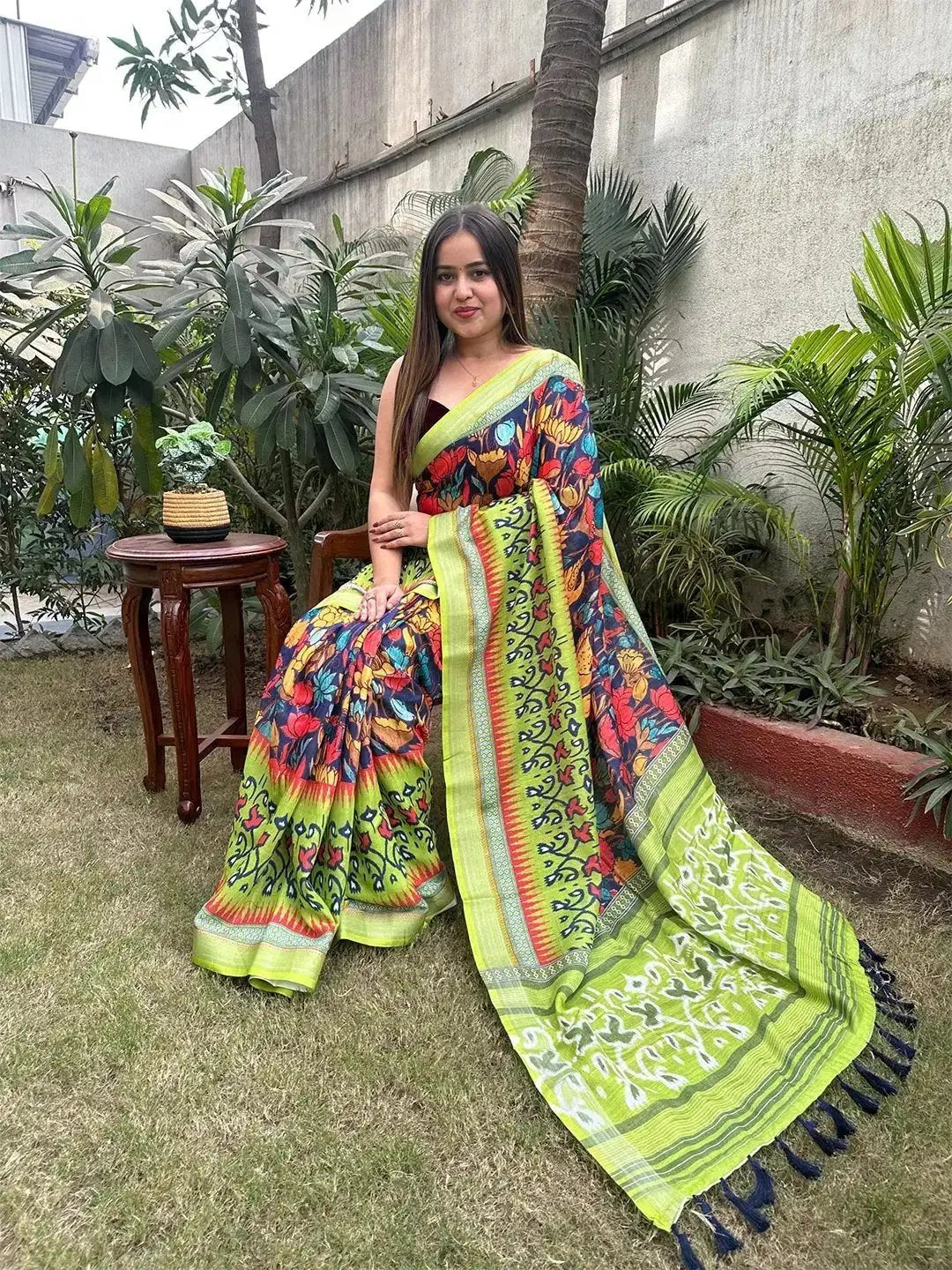 Woman in floral Ikkat printed party wear saree outdoors