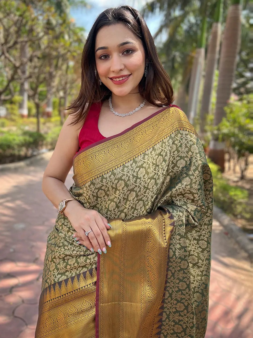 Model in green gold jacquard saree, showcasing intricate design