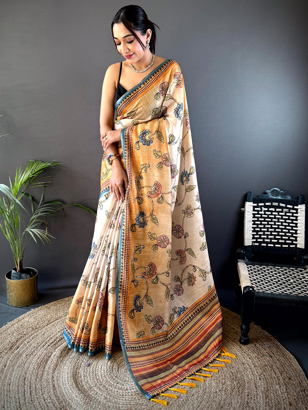 Shop Radiant Orange Zari Tussar Floral Saree featuring exquisite floral prints and a luxurious silk texture, perfect for festive and wedding occasions.