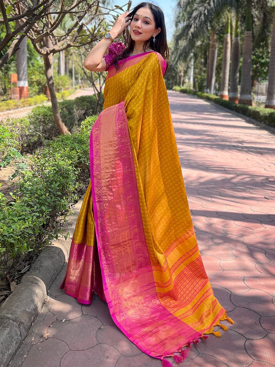 Side view of mustard Kanjivaram saree with pink accents