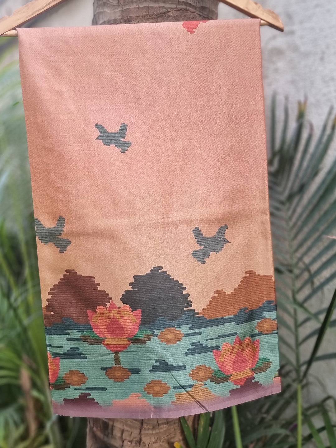 Tussar silk saree with freehand Ikkat Kalamkari print, hanging.