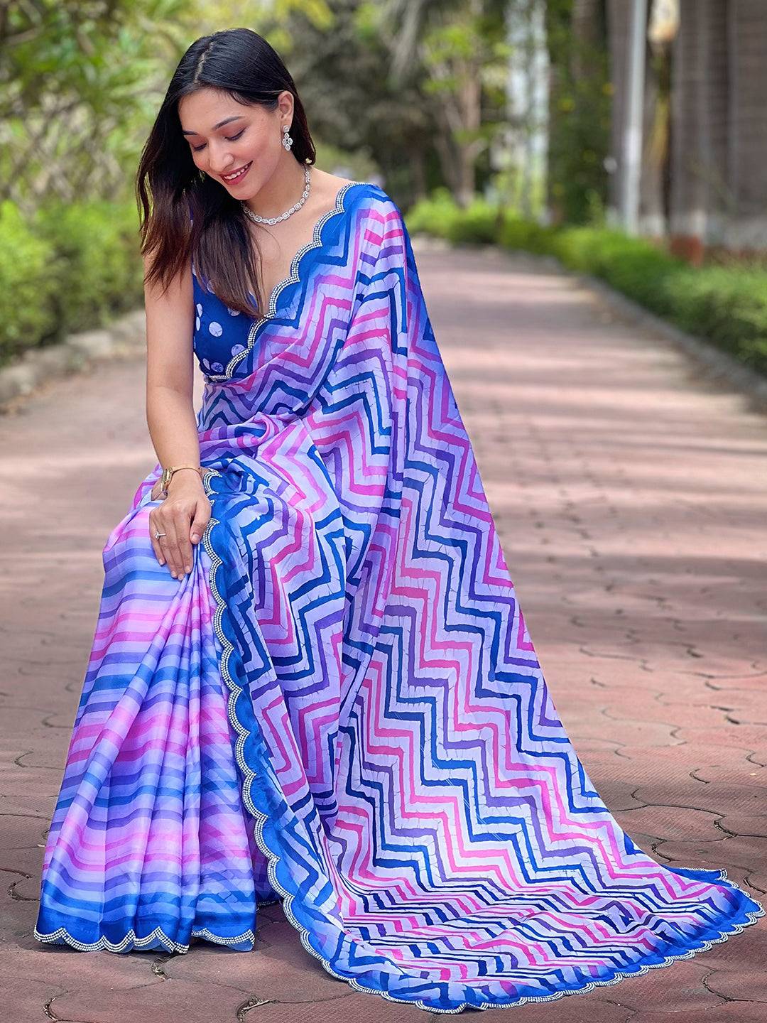 Woman seated wearing Leheriya and striped print saree