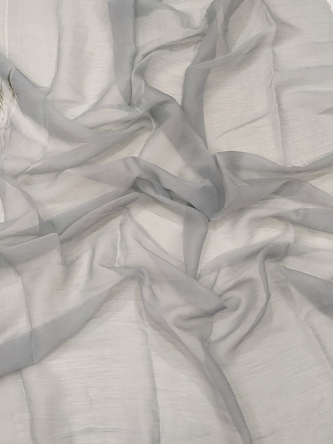 Close-up of soft chiffon satin fabric in light grey