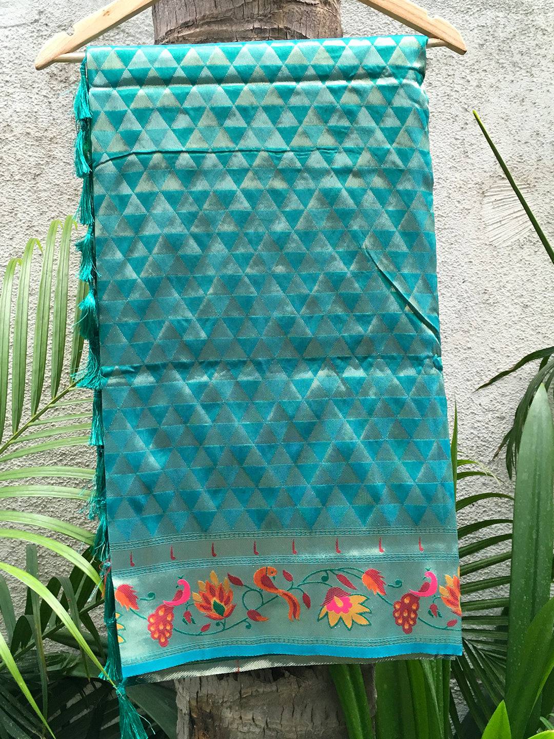 Folded Rama silk blend saree showcasing geometric and floral patterns