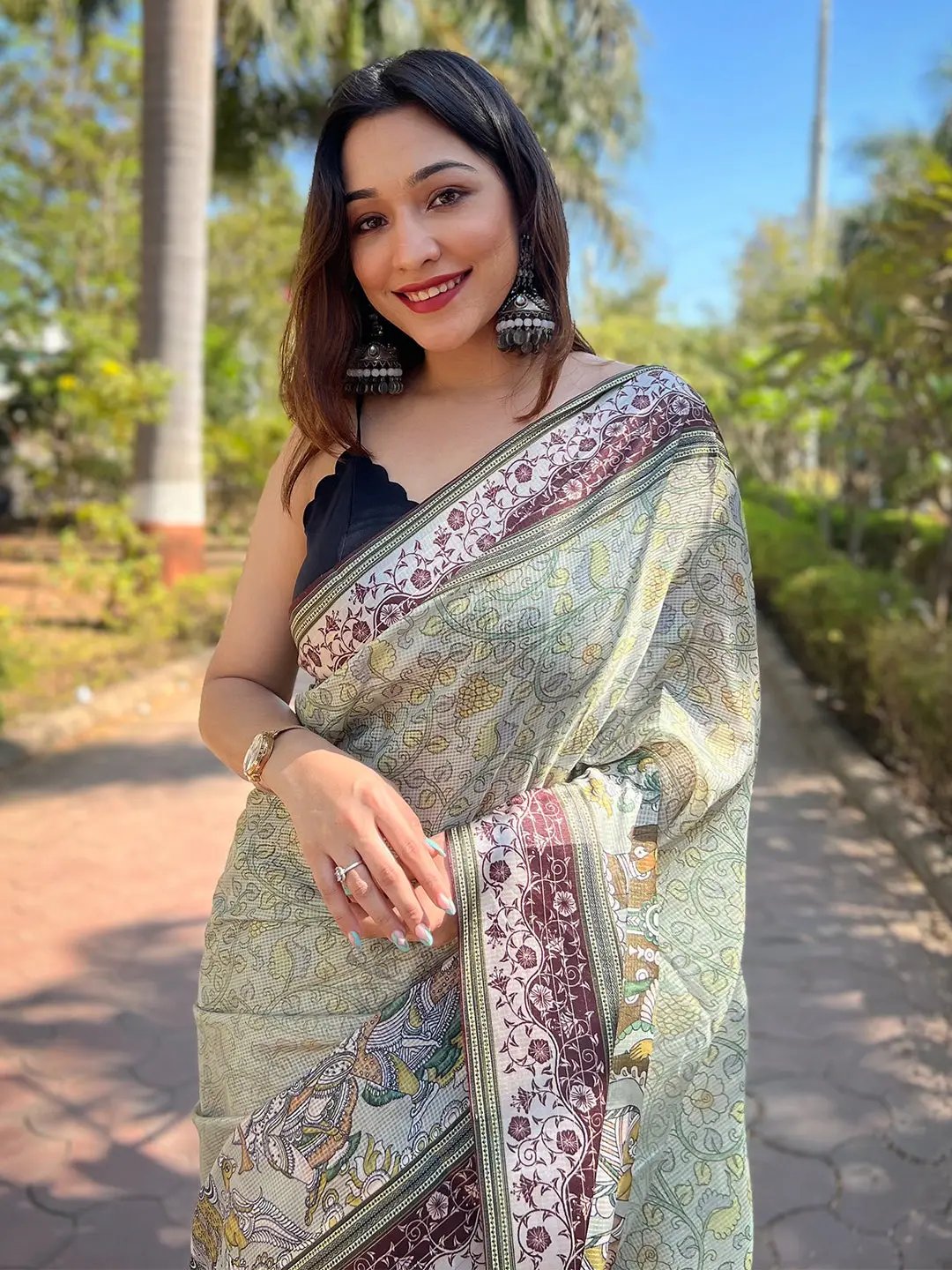 Model smiling in Pista Satin Kota Doria Saree with Kalamkari print