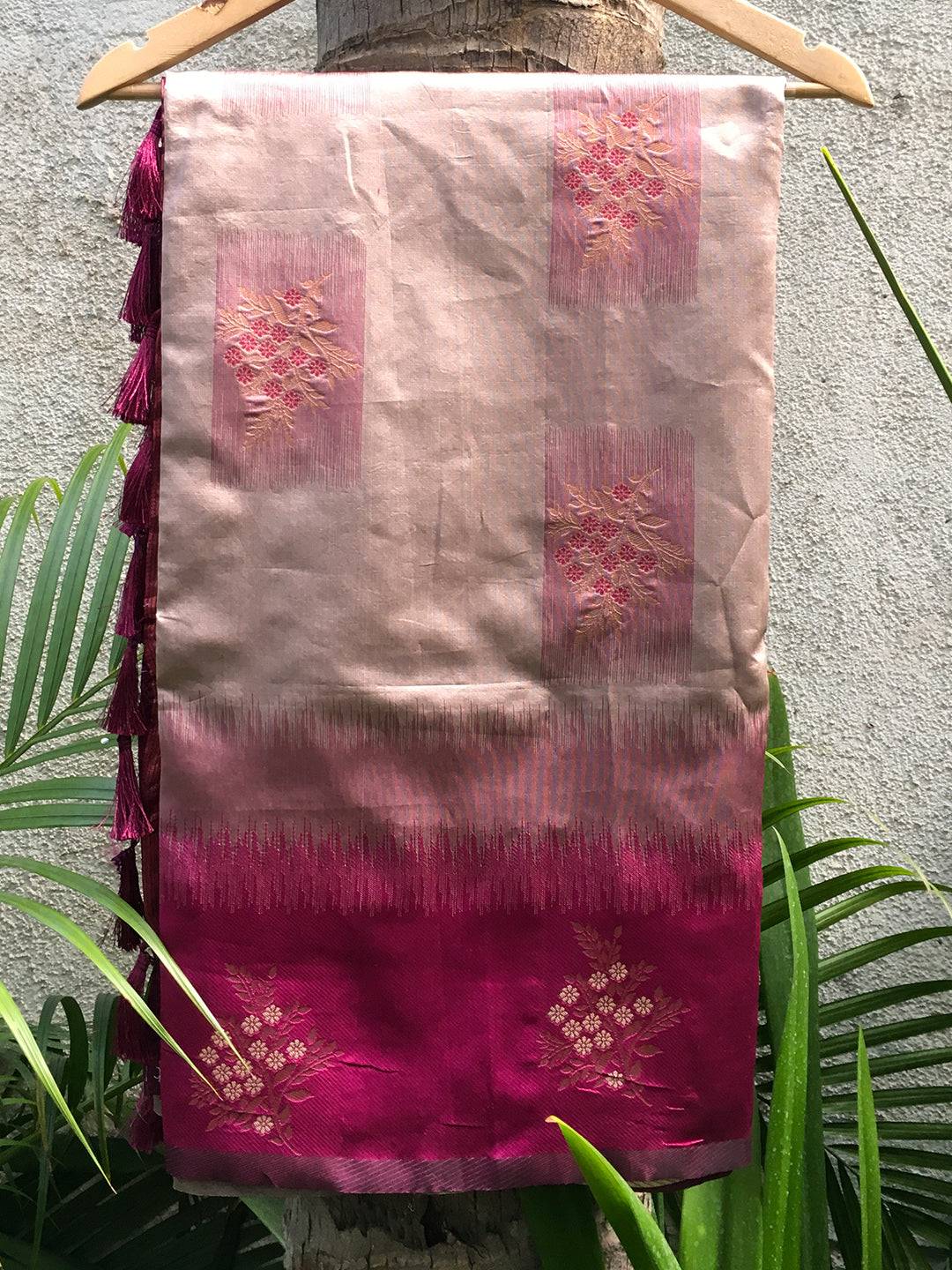 Close-up of magenta Banarasi Tussar silk saree on hanger.