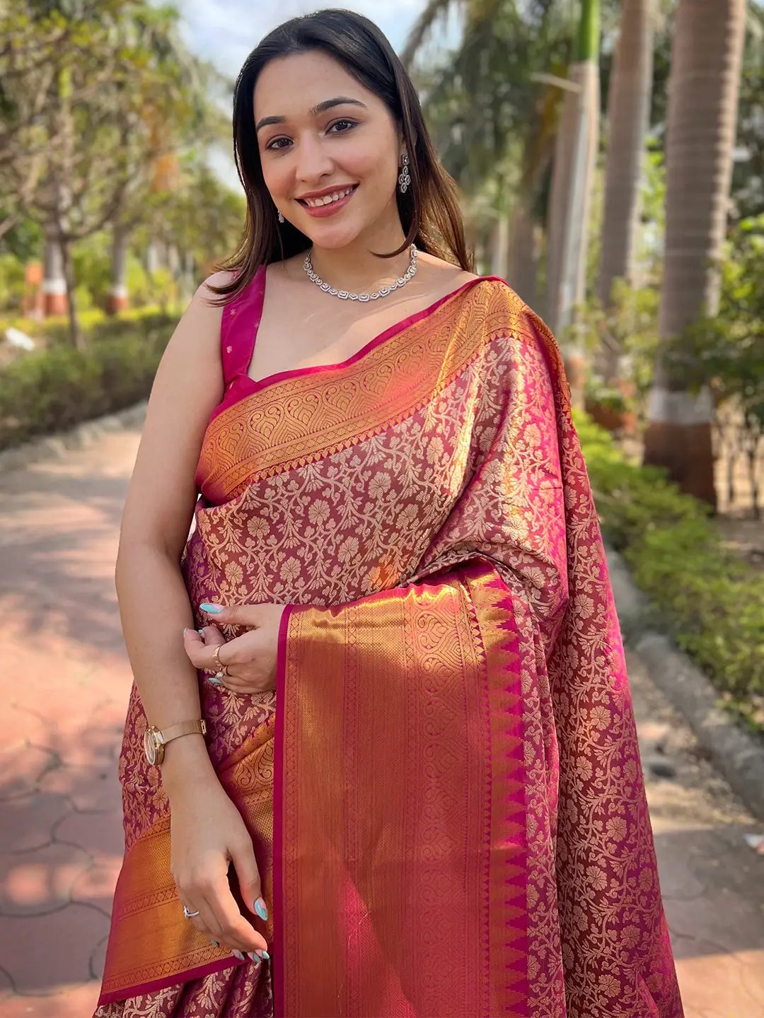 Model wearing pink gold tissue saree with jacquard details