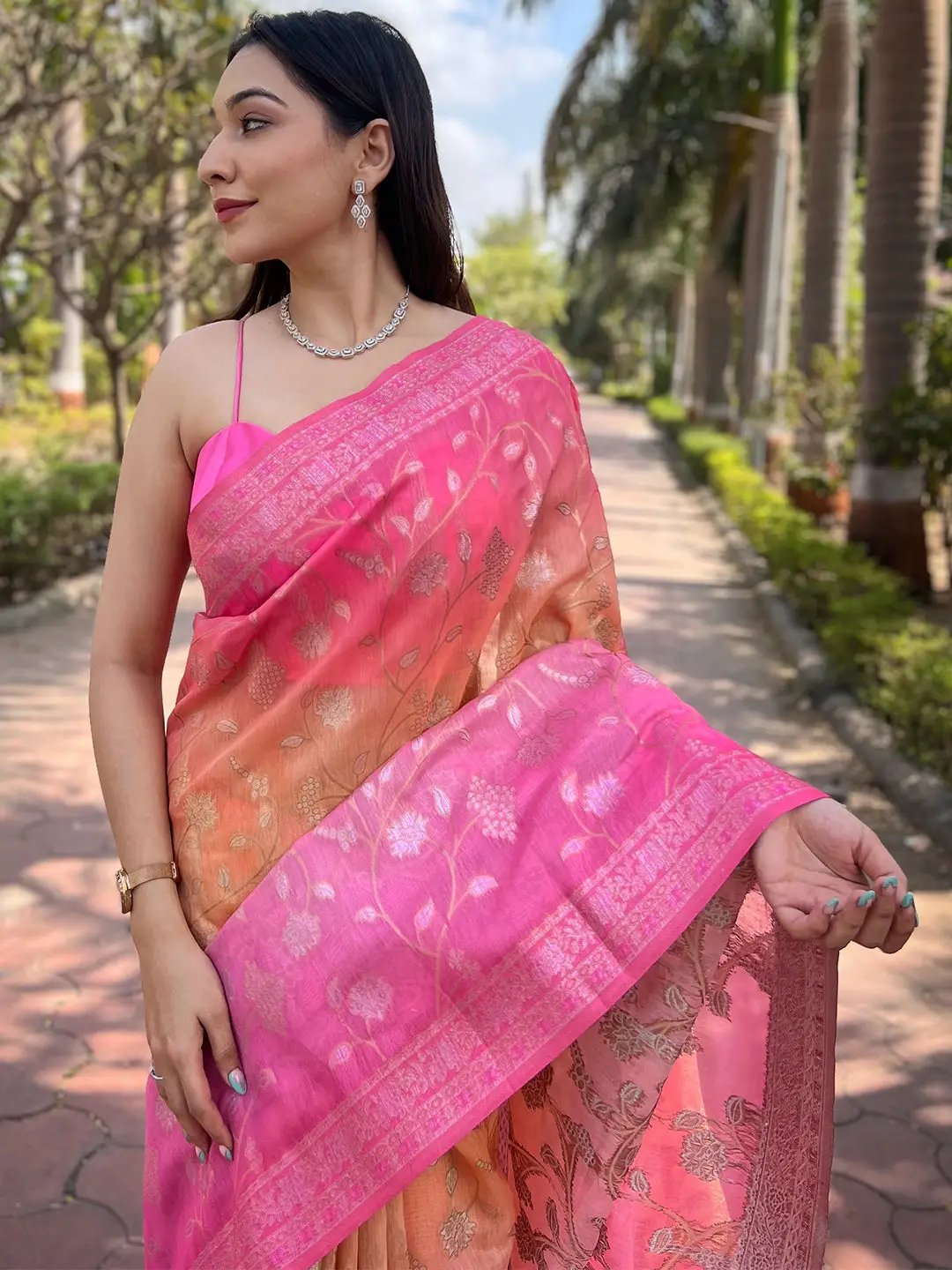 Close-up of pink saree showing zari and Lakhnavi details