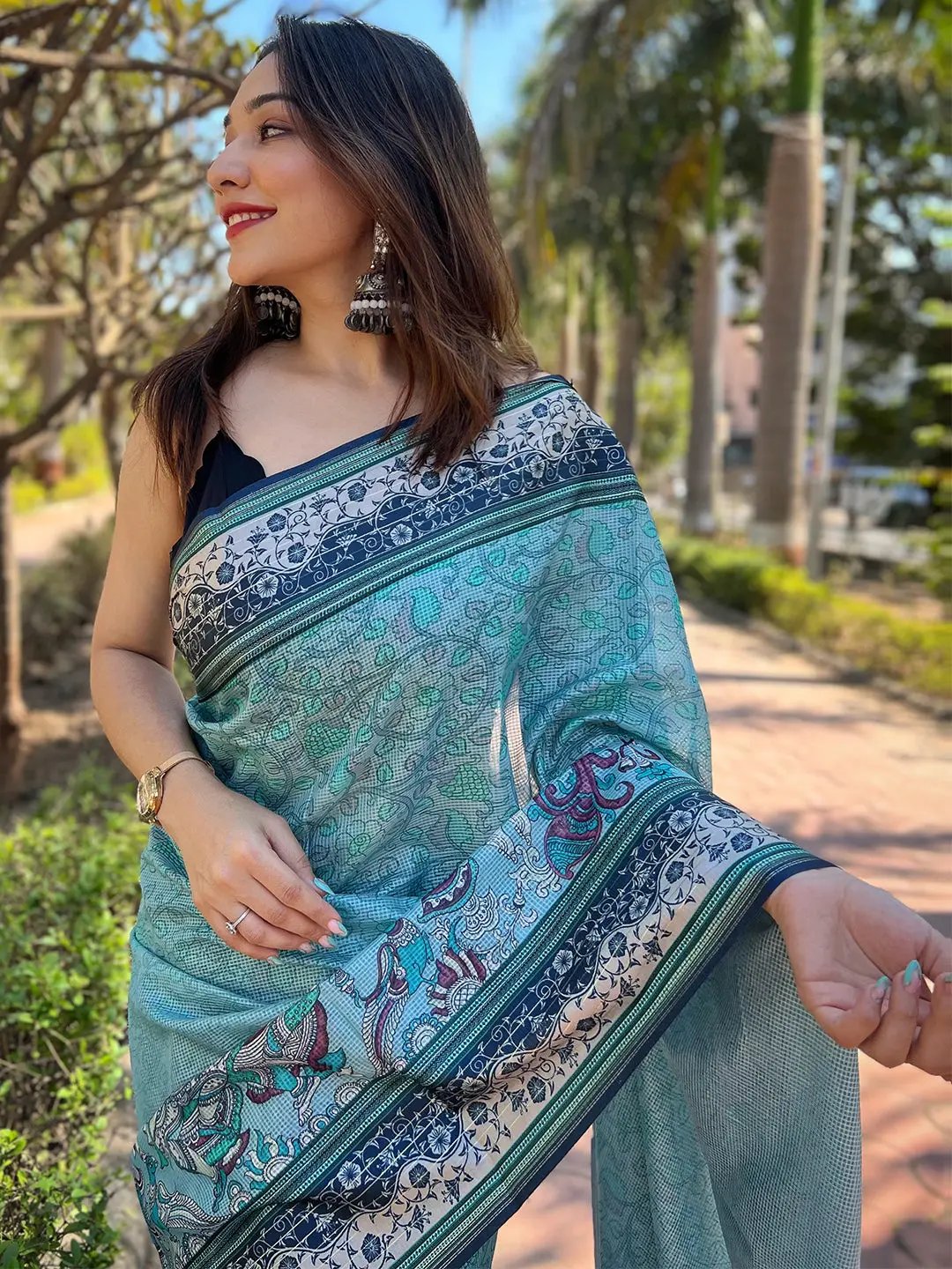 Close-up of Kalamkari print on Satin Kota Doria Saree in turquoise.