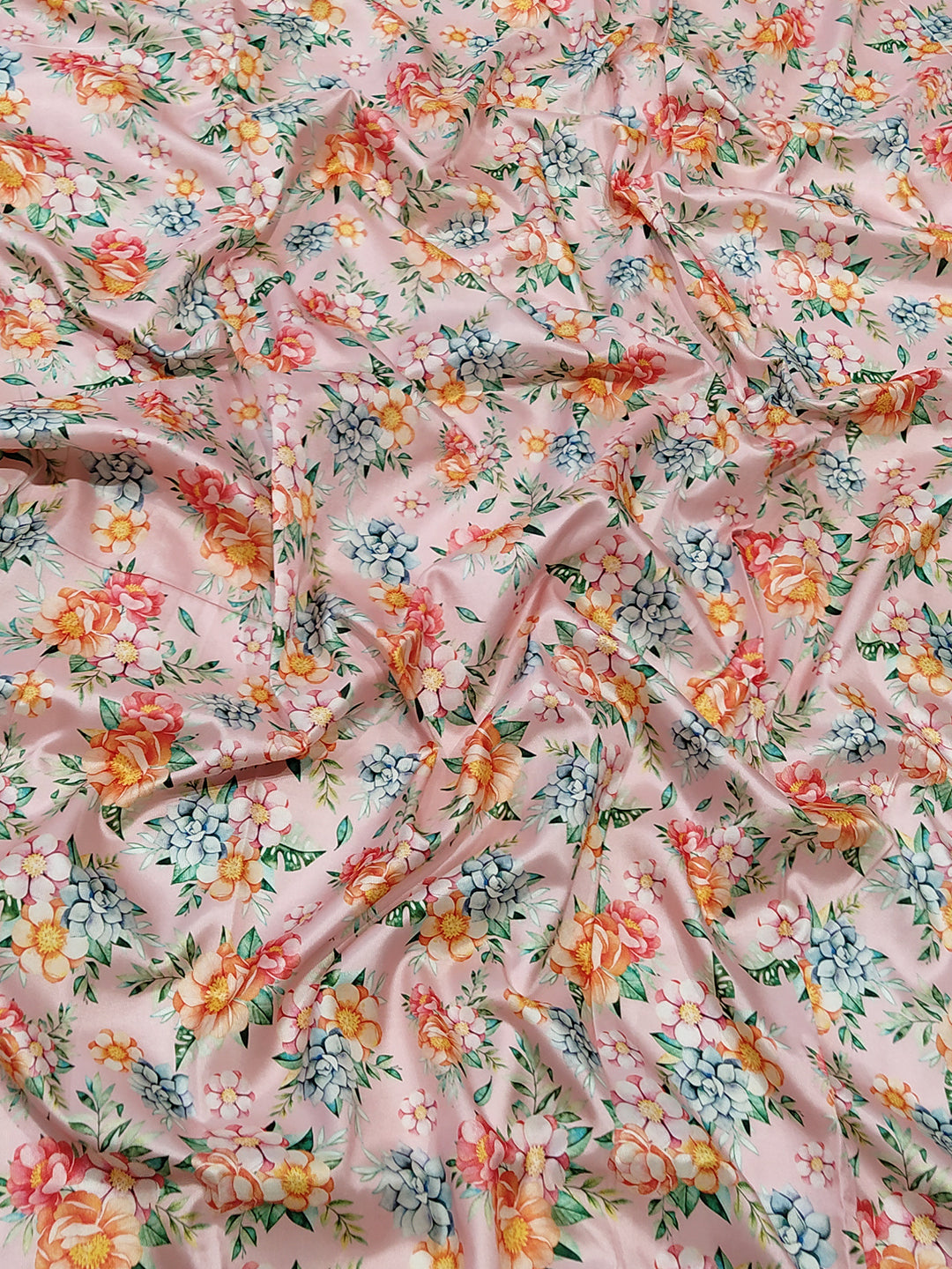 Close-up of floral print on pink Kanjivaram saree fabric