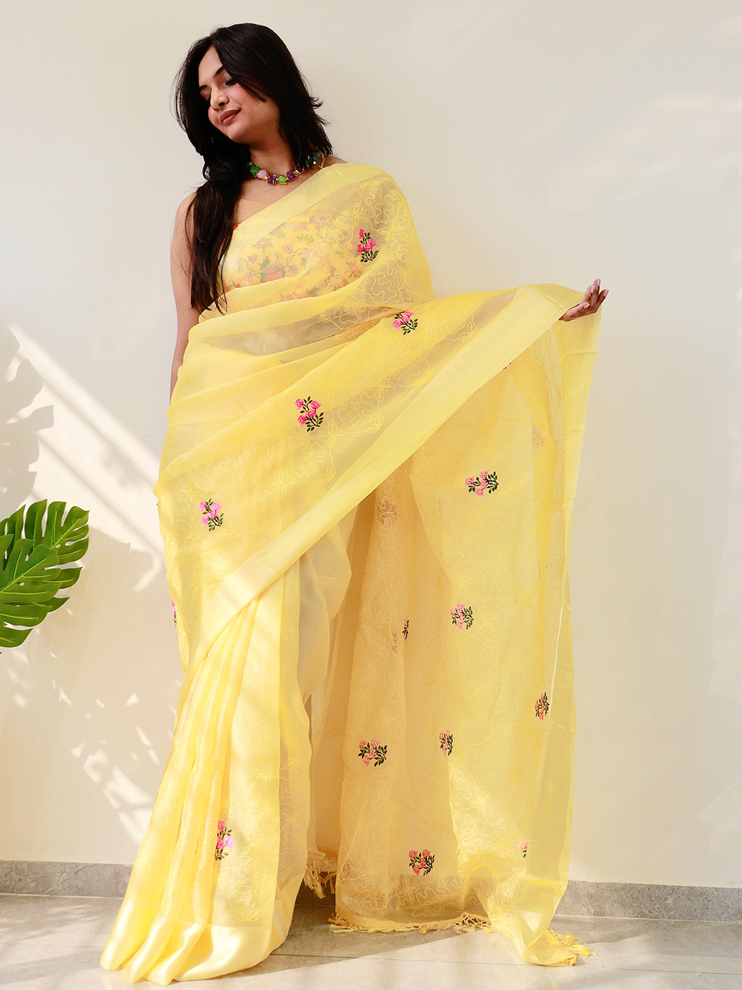 Yellow chiffon satin saree with floral embroidery, worn by model.