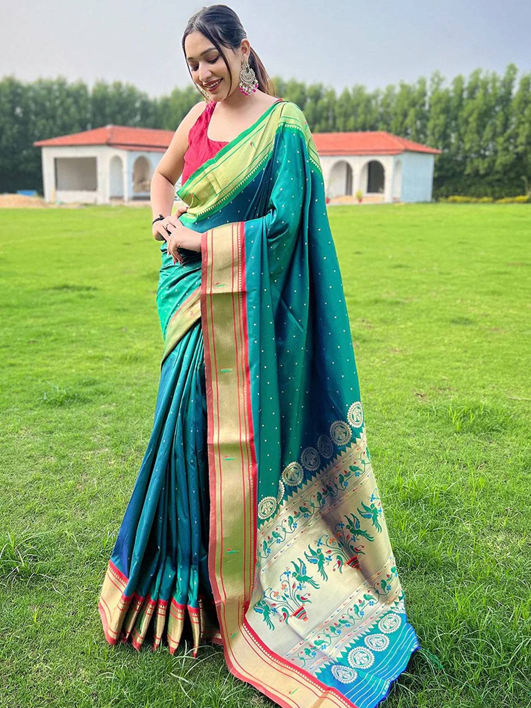 Teal Paithani saree with intricate Ganga Jamuna border design.