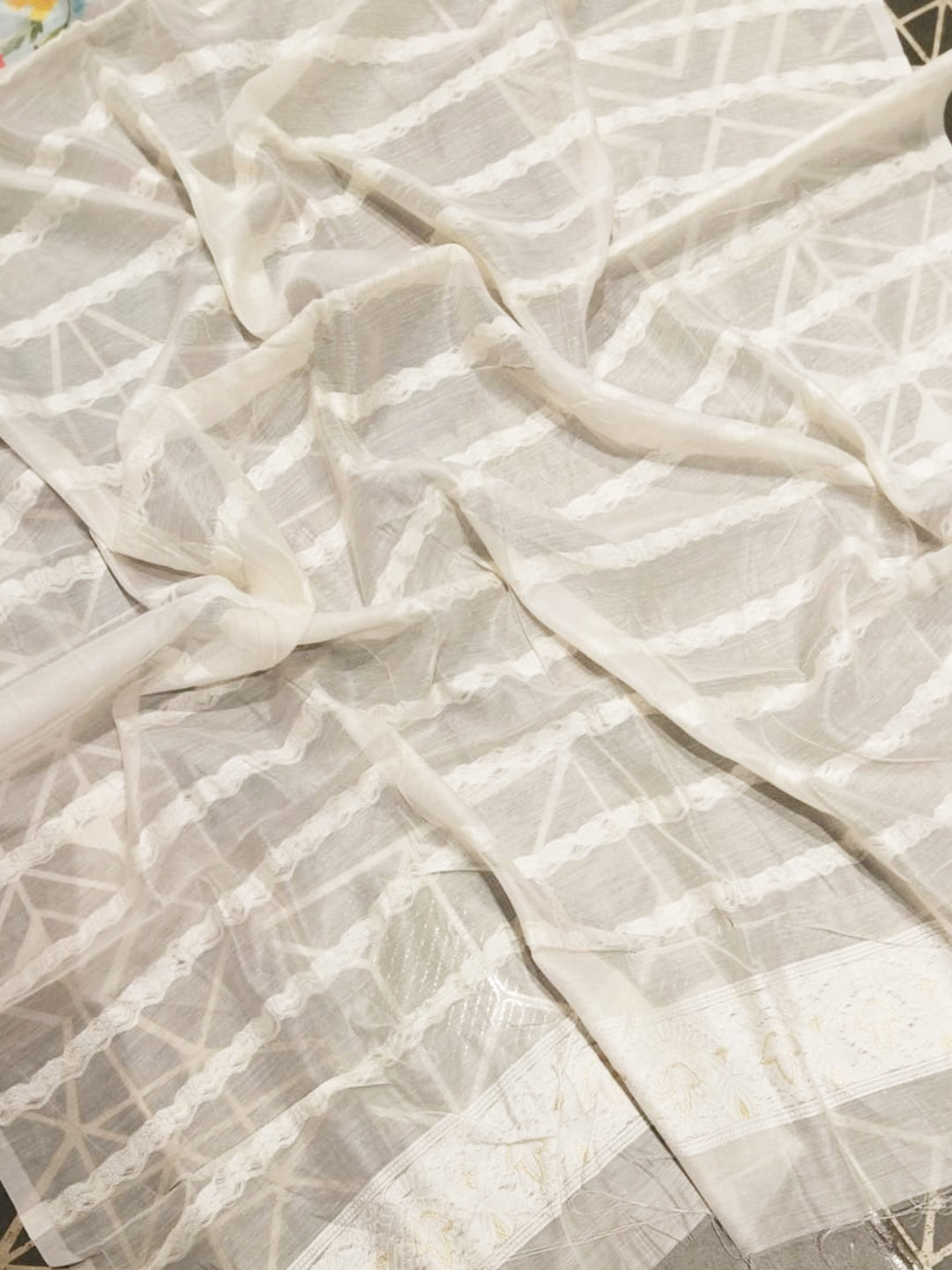 White saree fabric with subtle Lakhnavi patterns