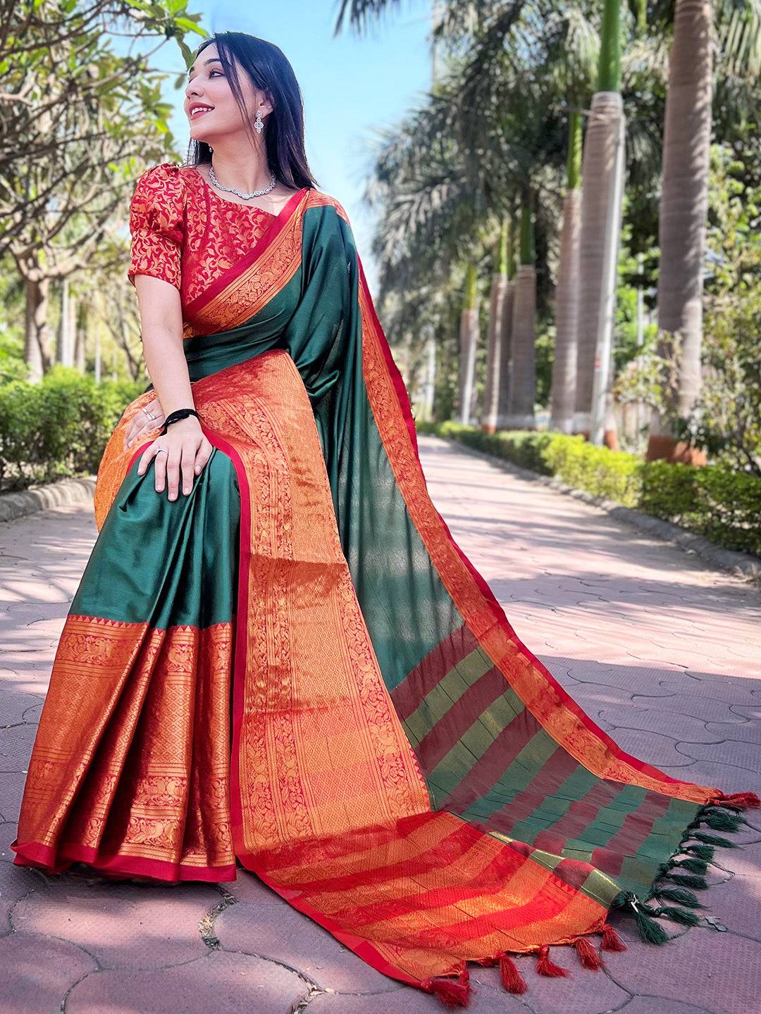 Bottle green Kanjivaram saree with detailed orange border