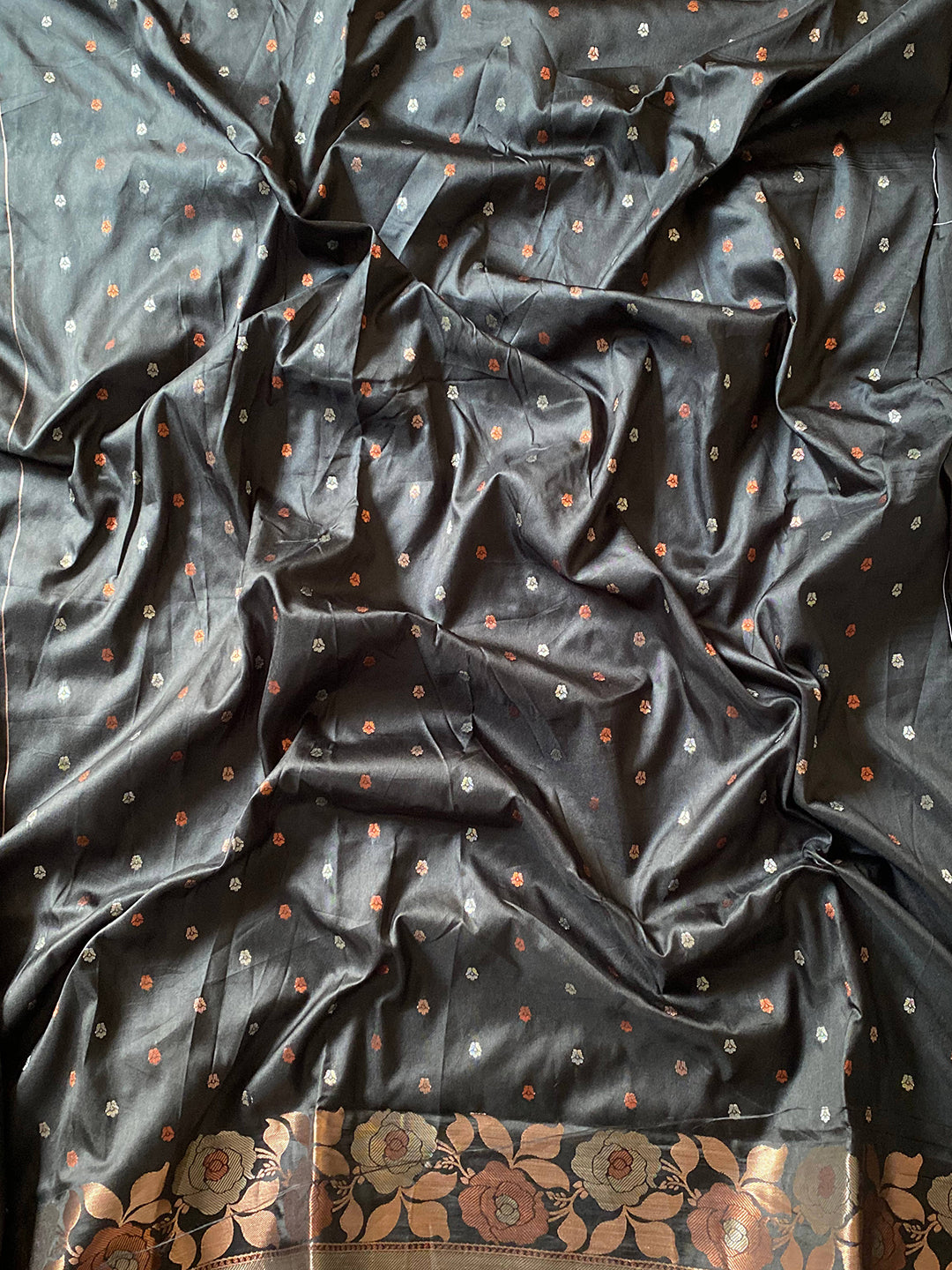 Close-up of black Banarasi silk saree with floral zari