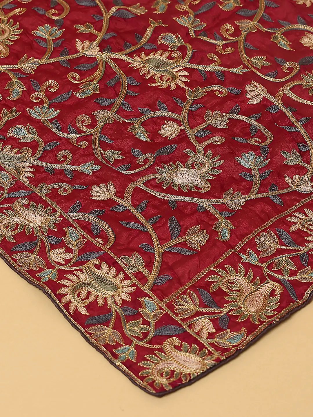 Close-up of embroidered motifs on wine poly chiffon dupatta