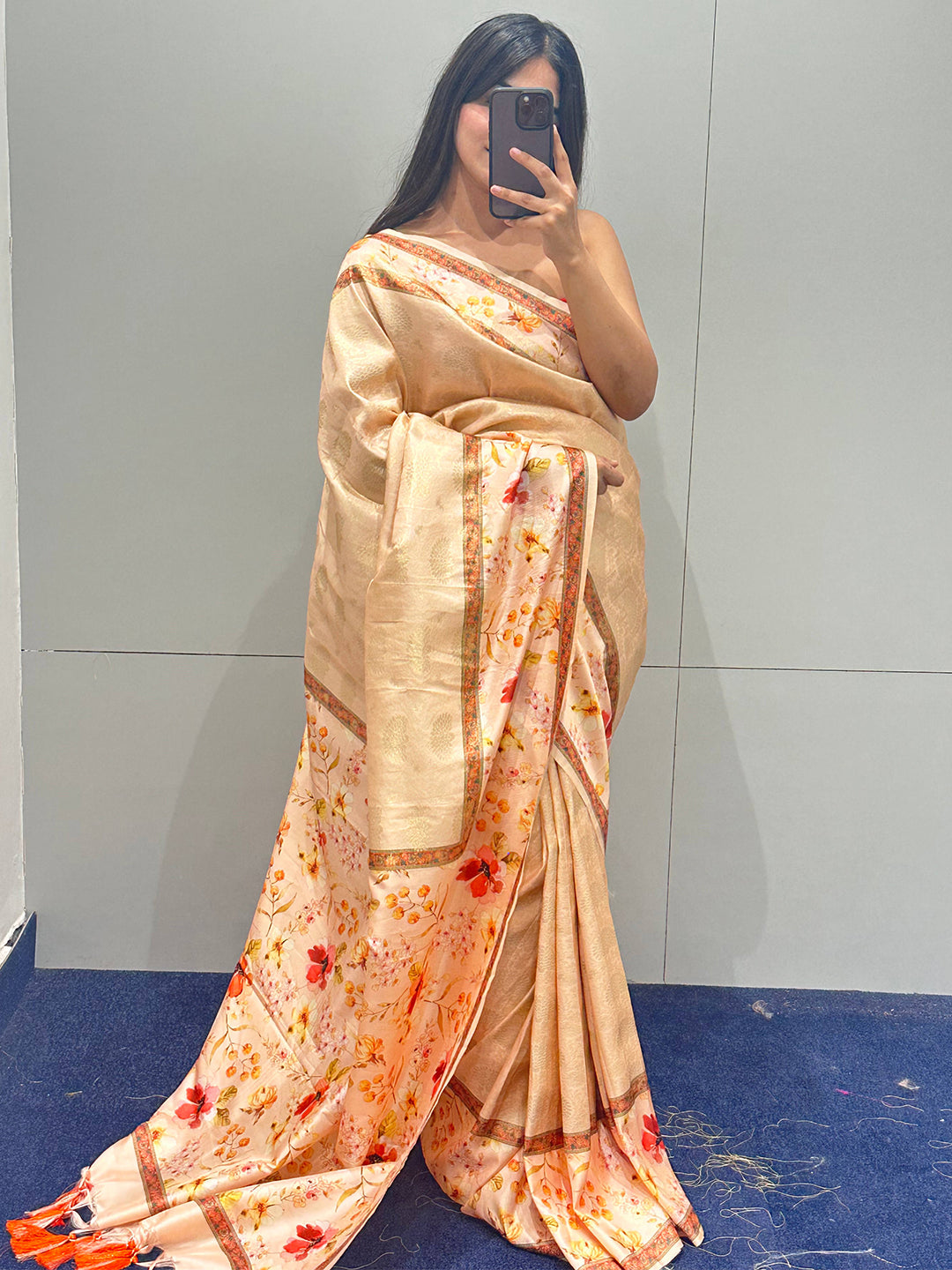 Peach floral Kanjivaram saree worn by woman in indoor setting