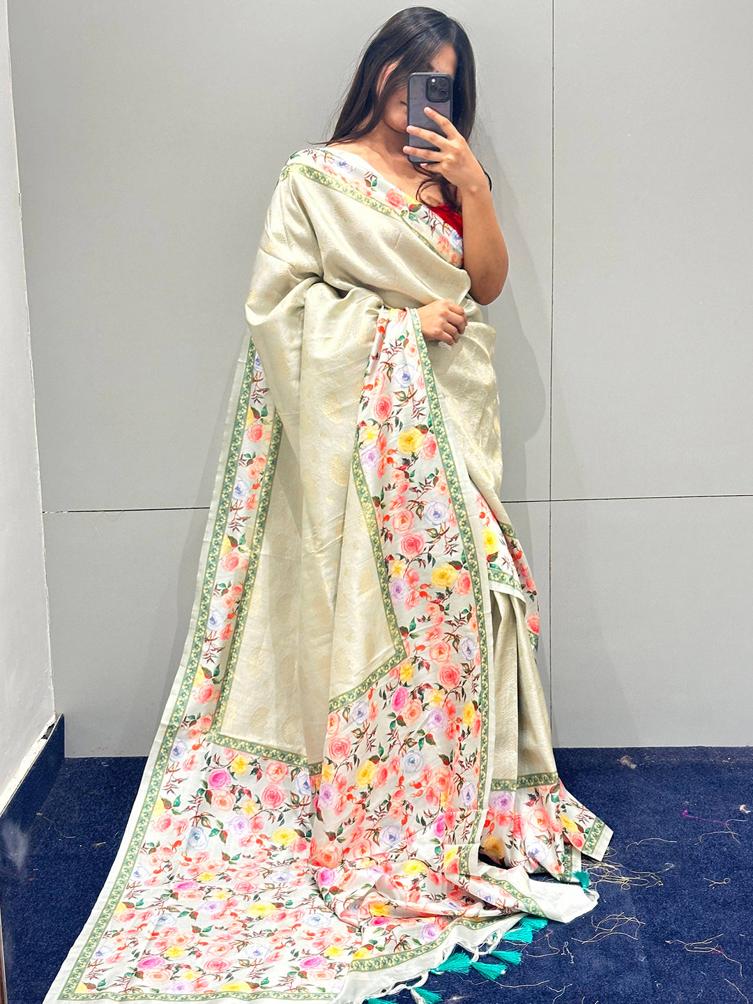 Woman posing in a floral print Kanjivaram saree.