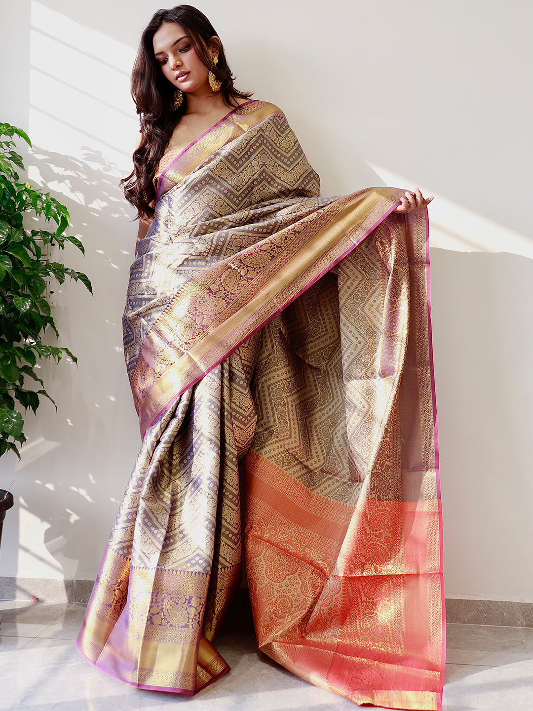 Elegant gold zari Kanjivaaram pattu silk saree draped.