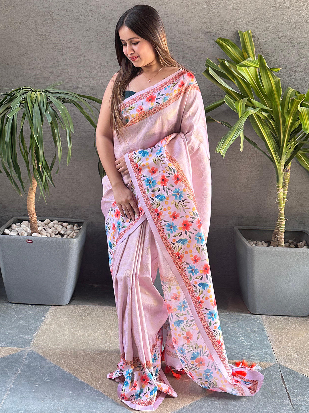 Light pink Kanjivaram saree with floral print, standing view