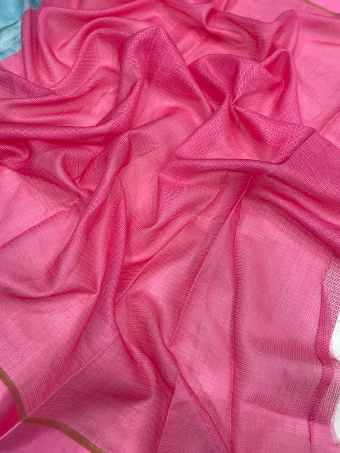 Close-up of pink satin Kota Doriya saree fabric