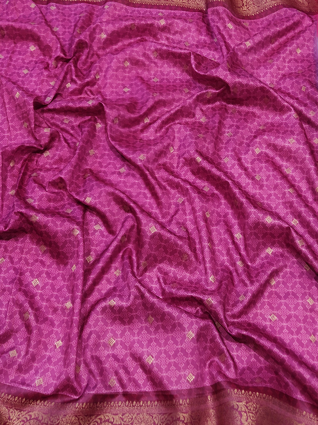 Rich pink jacquard fabric with intricate Banarasi weaving design