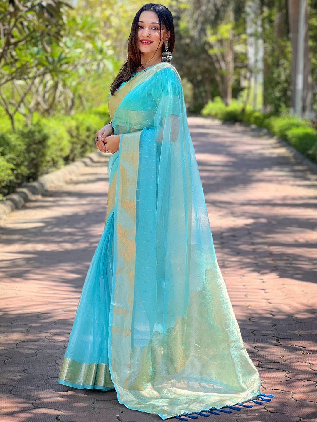 Elegant turquoise organza saree with fine gold zari border