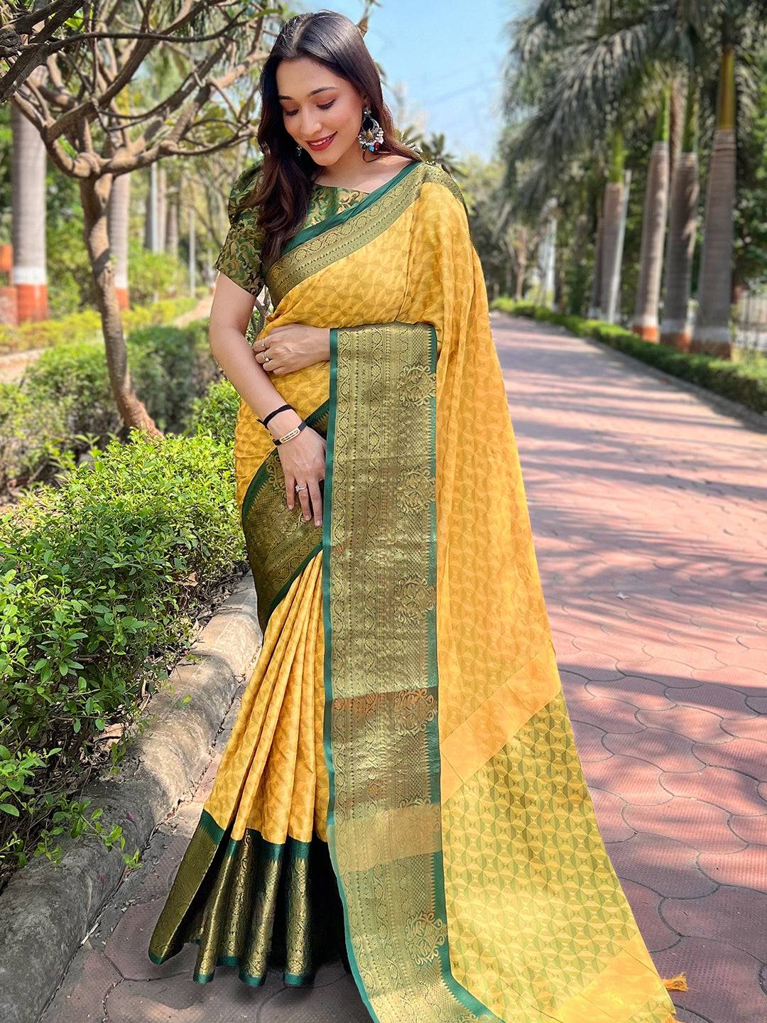 Elegant yellow Kanjivaram saree with intricate green border