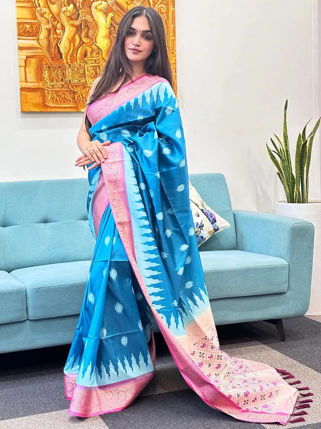 Elegant blue Banarasi saree with pink zari patola pallu on model.