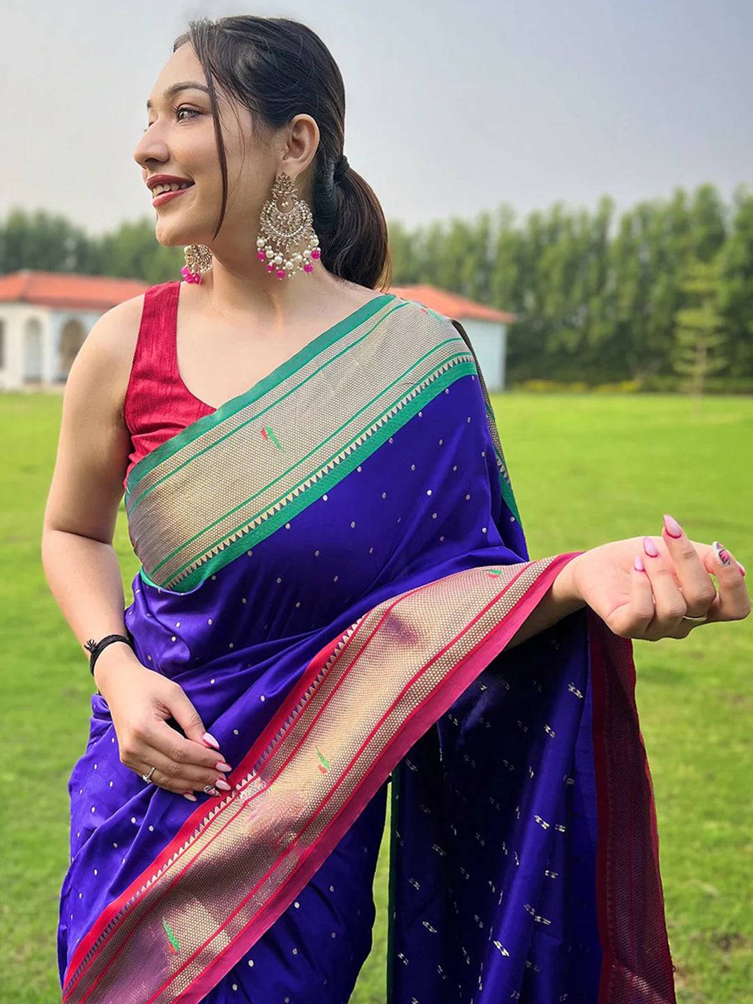 Violet Paithani saree with Ganga Jamuna border, worn outdoors