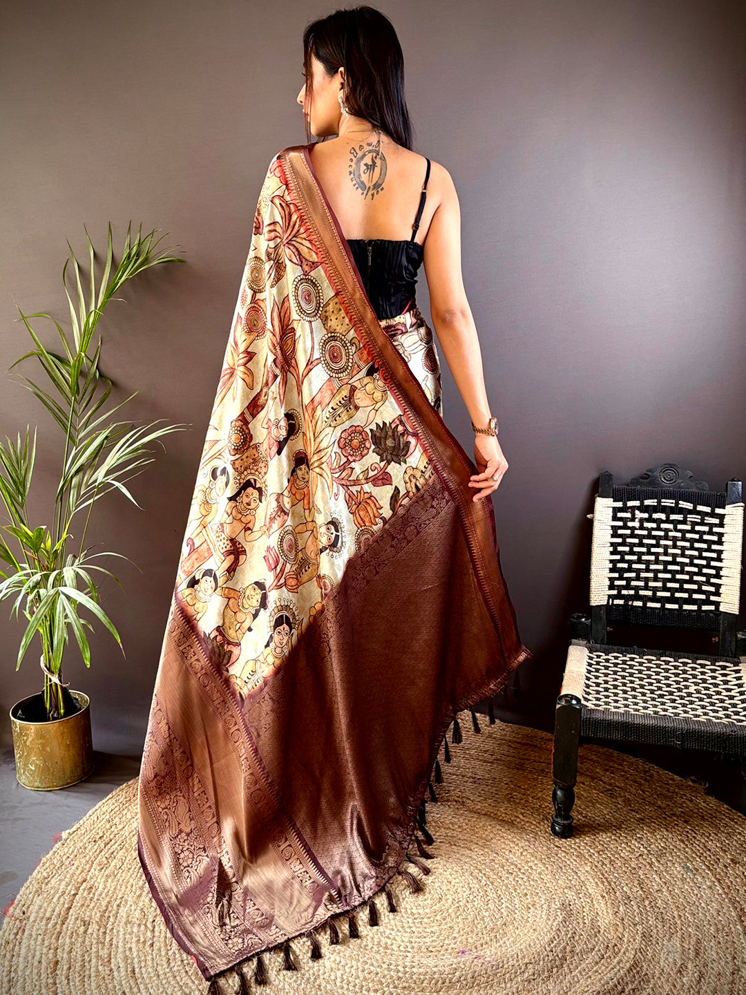 Back view of brown silk saree with detailed pattu zari border