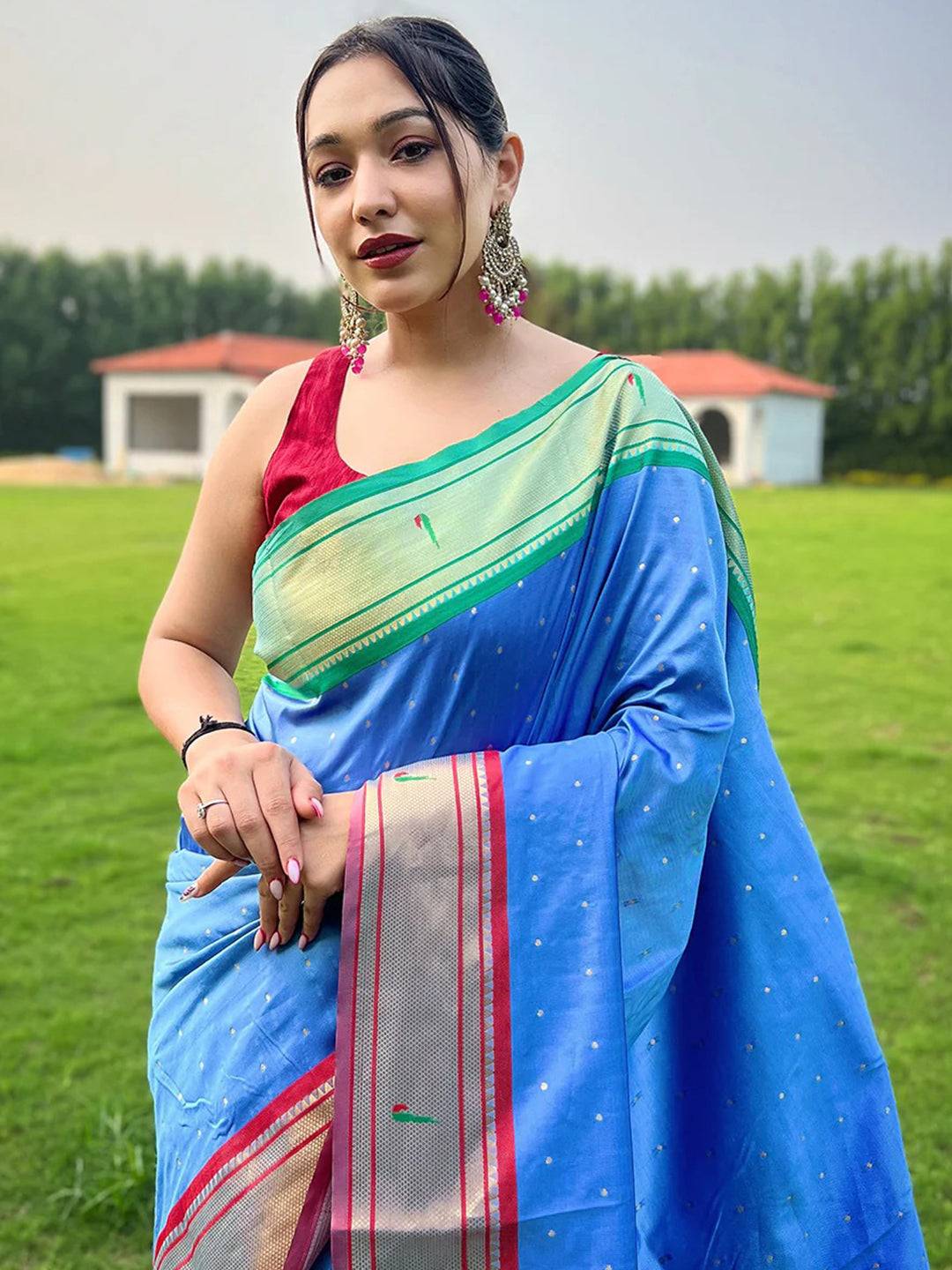 Woman wearing Sky Blue Paithani Saree with Ganga Jamuna border