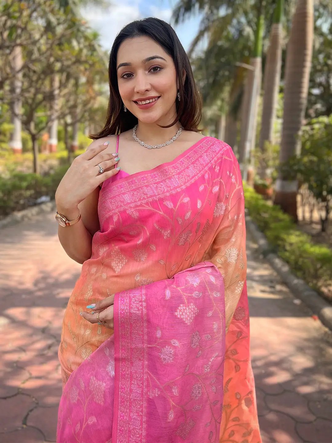 Woman smiling in elegant pink slub silk saree