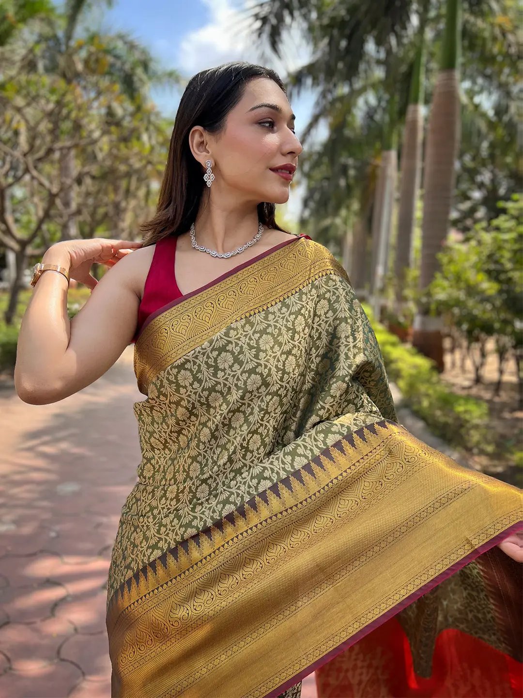 Close-up of green gold jacquard saree, worn by model