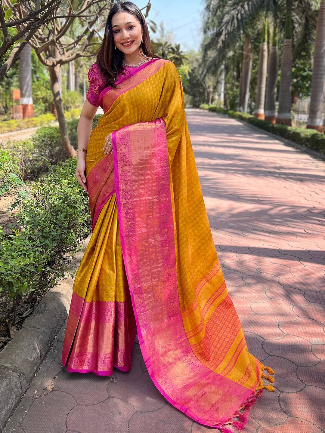 Full view of mustard Kanjivaram saree with pink zari border