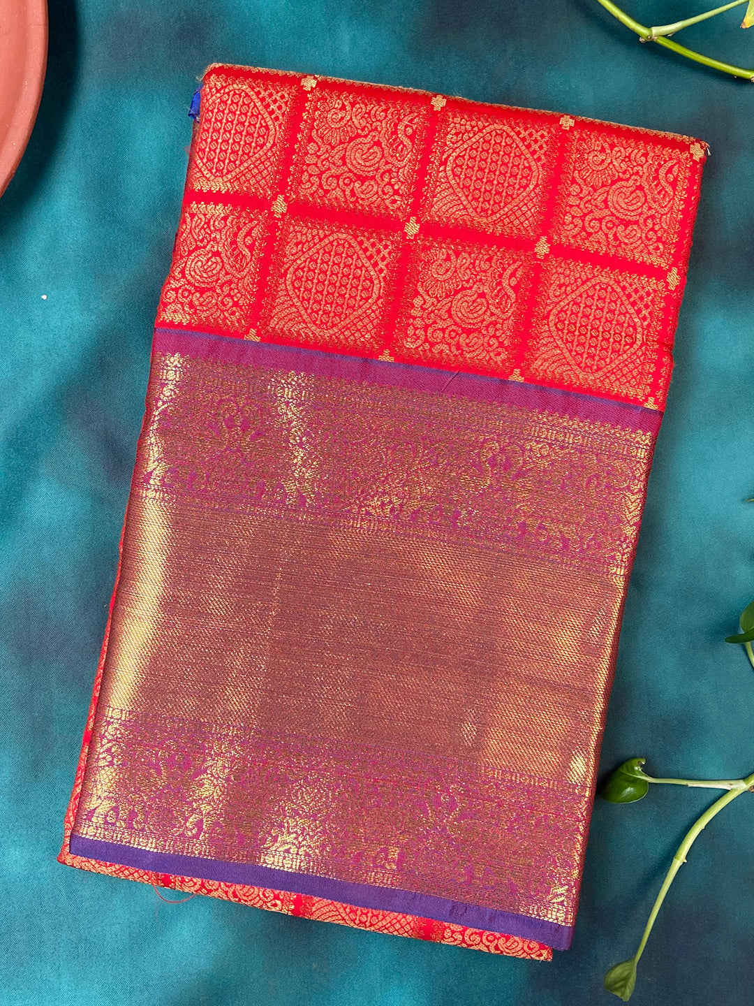 Red Kanjivaram silk saree with checked print folded