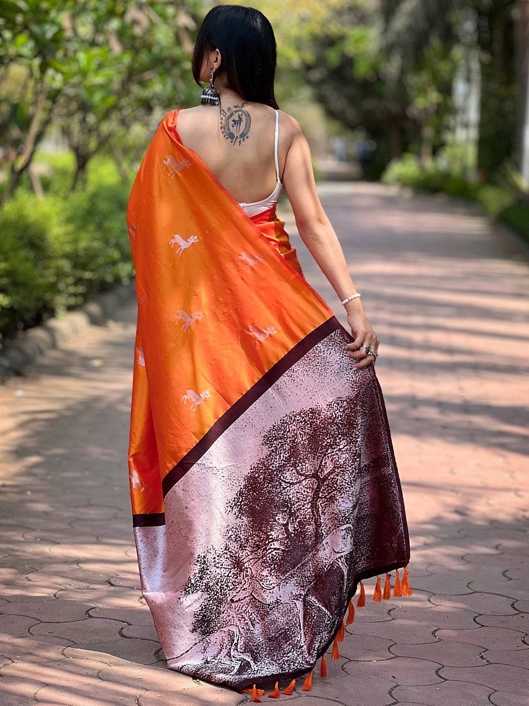 Back view of orange saree showing zari pallu design