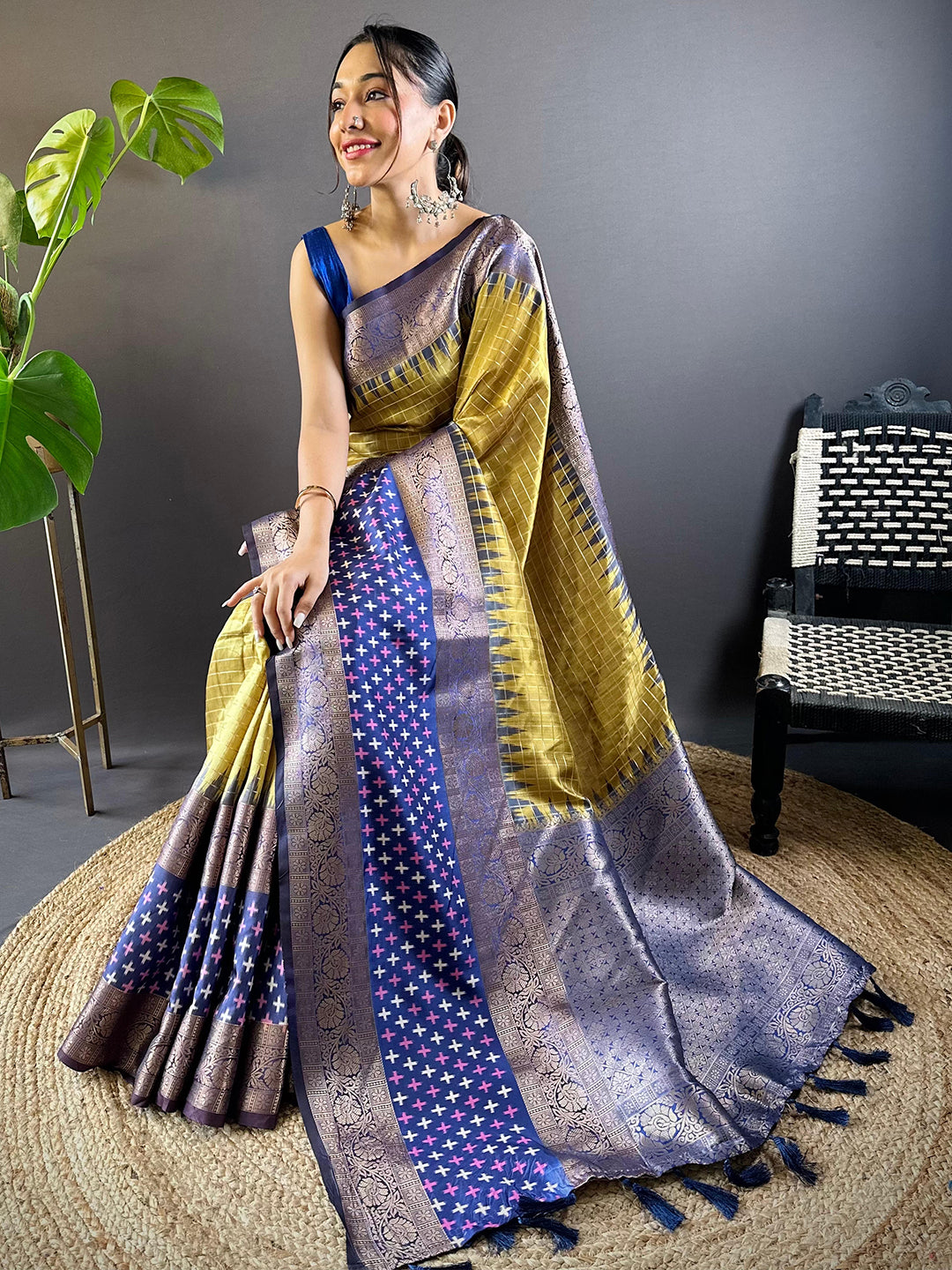 Seated model in Green Chex Ikkat Saree with Double Border