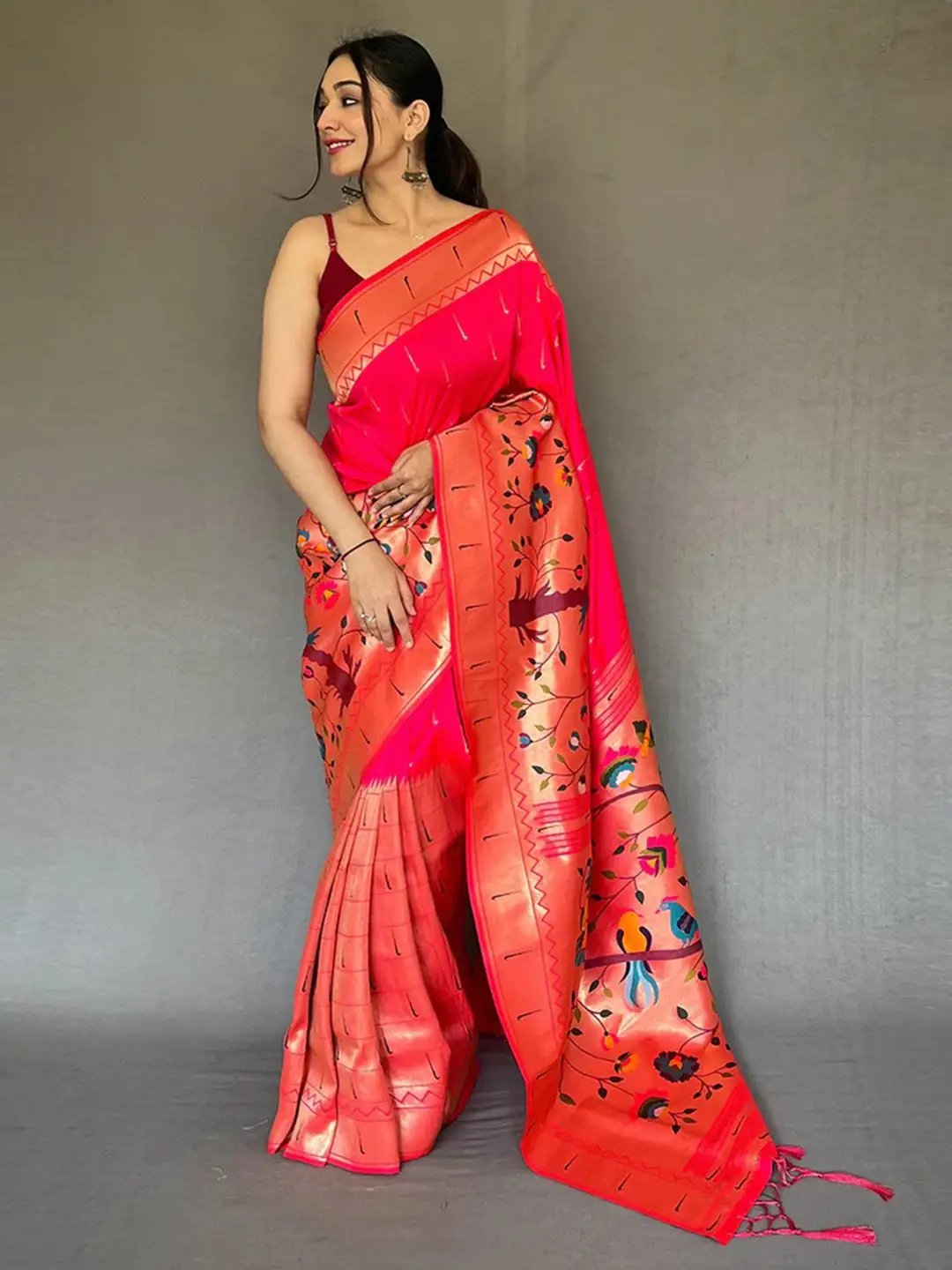 Model wearing pink Paithani saree with big zari border