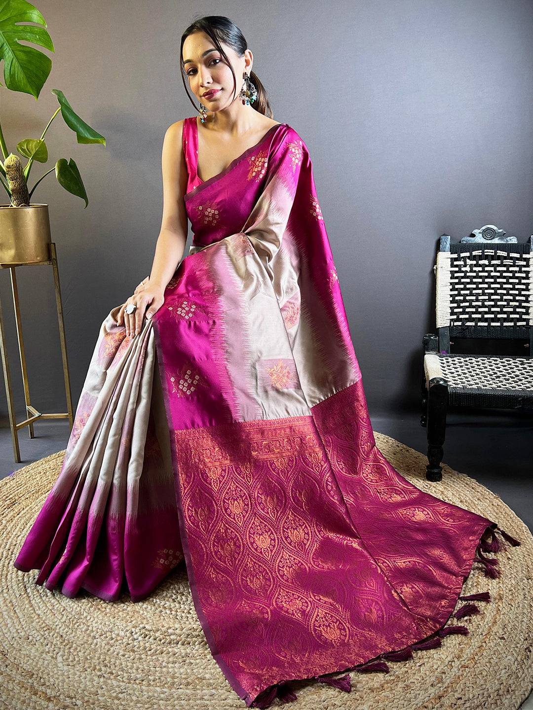 Sitting pose in magenta Banarasi Tussar silk saree highlighting rich texture.